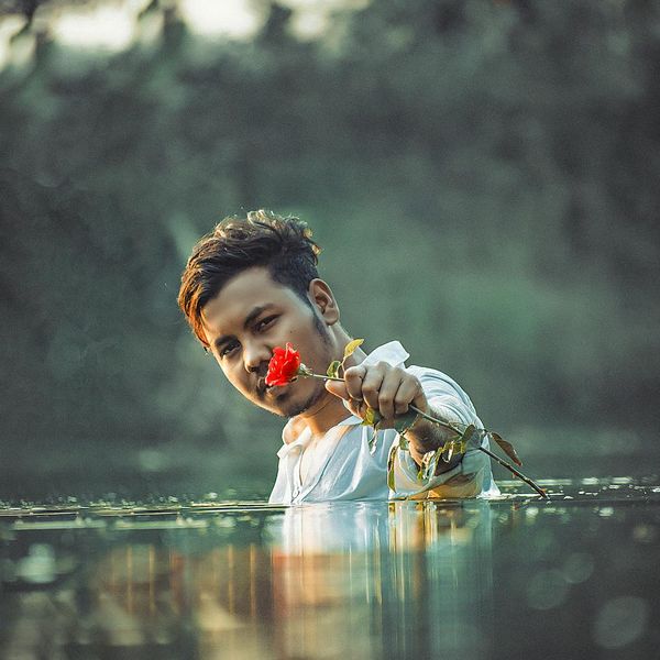 Person stretching gently outdoors with a calm and focused expression.